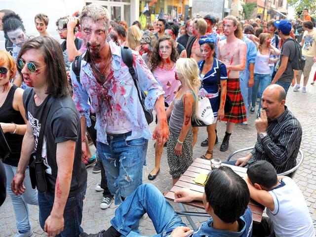 People dressed up as zombies take part in the Zombie Walk event.