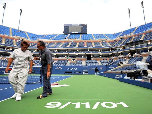 Event Staff look over the stencil prior to the start of the Men's semifinal 2011 US Open match.