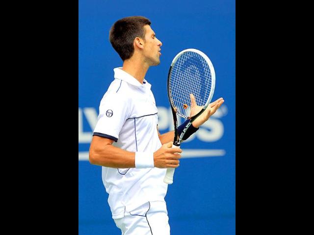 Novak Djokovic reacts during the Men's semifinal 2011 US Open match against Roger Federer.