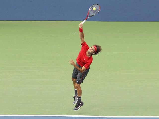 Roger Federer serves to Novak Djokovic during a semifinal match at the US Open tennis tournament in New York.