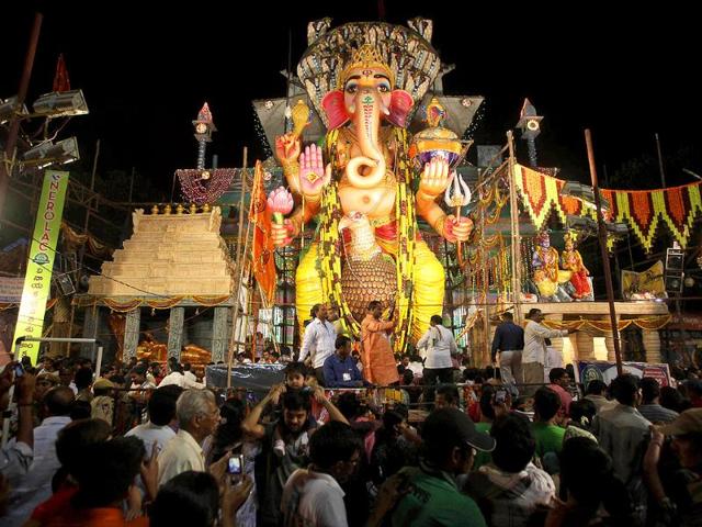 Indian Hindu devotees worship an idol of elephant-headed Hindu God Ganesha during the Ganesh Chaturthi festival in Hyderabad.