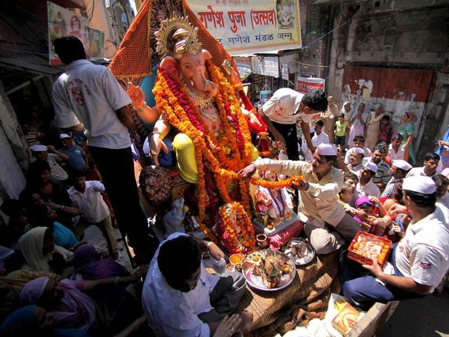 An idol of elephant-headed Hindu God Ganesha is taken for immersion in the River Tawi during Ganesh Chaturthi festival in Jammu.