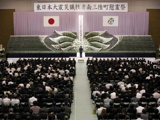 People attend a memorial service for victims of the March 11 earthquake and tsunami in Minamisanriku town, Miyagi prefecture.
