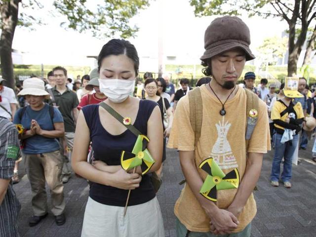 Demonstrators observe a moment of silence at 2:46pm, when Japan marked the passing of exactly six months since the March 11 earthquake and tsunami, at the start of an anti-nuclear protest in Tokyo.
