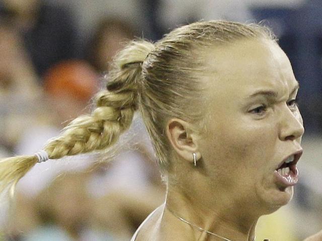 Caroline Wozniacki of Denmark returns a shot to Serena Williams during a semifinal match at the US Open tennis tournament in New York.