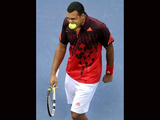 Jo-Wilfried Tsonga from France puts a ball in his mouth after a missed point against Mardy Fish of the United States during their men's 2011 US Open match at the USTA Billie Jean King National Tennis Center in New York.