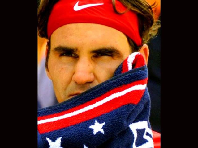 Roger Federer of Switzerland sits between games against Marin Cilic of Croatia during their men's match at the USTA Billie Jean King National Tennis Center in New York.