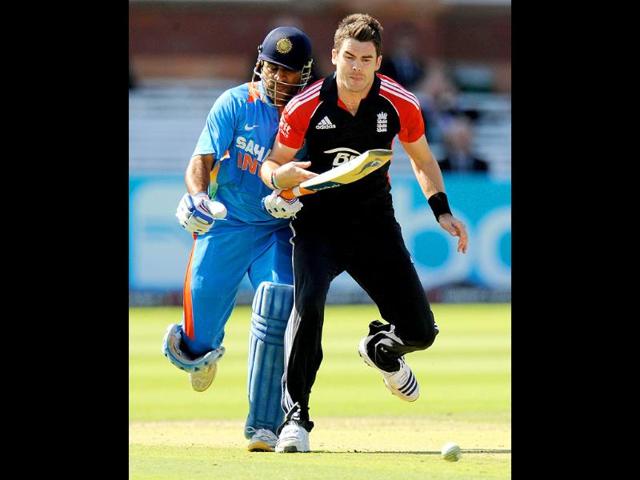 England's James Anderson (R) collides with India's captain Mahendra Singh Dhoni during the fourth ODI match at Lord's cricket ground in London.