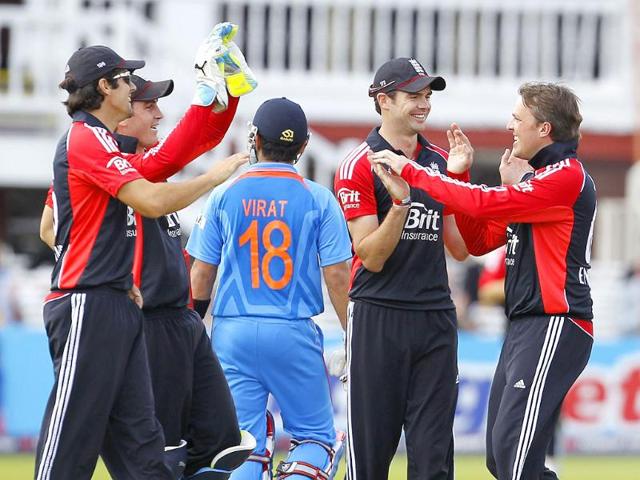 England's Graeme Swann celebrates taking the wicket of India's Virat Kohli (c) for 16 runs during the fourth One Day International (ODI) cricket match between England and India at Lord's cricket ground in London.