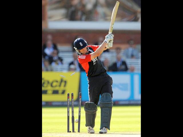 England's Jonathan Trott is bowled by India's Praveen Kumar for 23 during the fourth One Day International (ODI) cricket match at Lord's cricket ground in London.