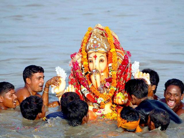 Devotees immerse an idol of Lord Ganesha to mark the end of 11 Days Ganesh festival in New Delhi on Sunday
