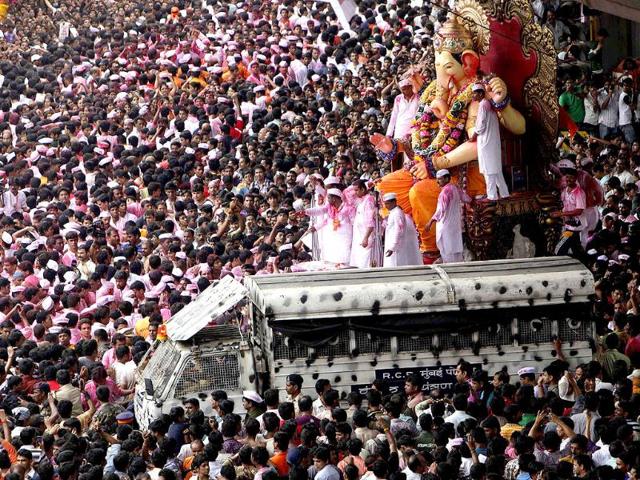 Devotees surround an idol of Lord Ganesh during a procession to immerse it in the Arabian Sea at the end of a ten day festival in Mumbai.