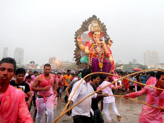 Hindus throng the beach as they pull a huge idol of Lord Ganesha for immersion into the Arabian Sea in Mumbai.