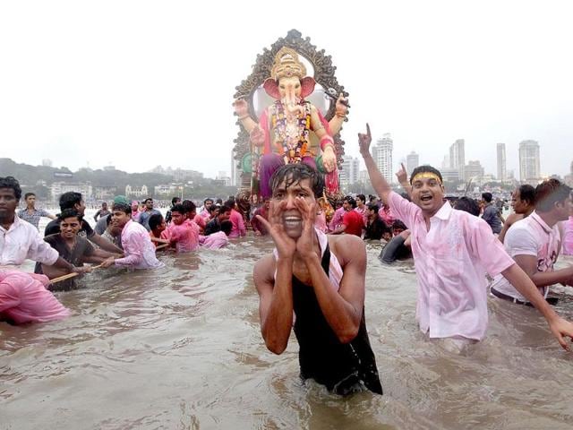 Hindu devotees immerse the idols of Lord Ganesh in the Arabian Sea in Mumbai.