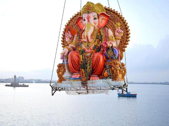 Hindu devotees prepare to immerse an idol of the Hindu God Ganesh into the Hussain Sagar Lake in Hyderabad.