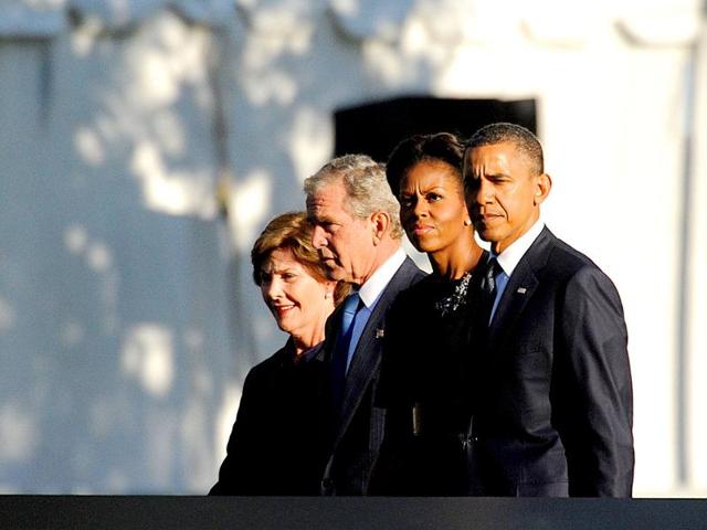 US President Barack Obama, first lady Michelle Obama, former President George W Bush and Mrs Laura Bush walk past the North Pool at the 9/11 Memorial at the World Trade Center site in New York.