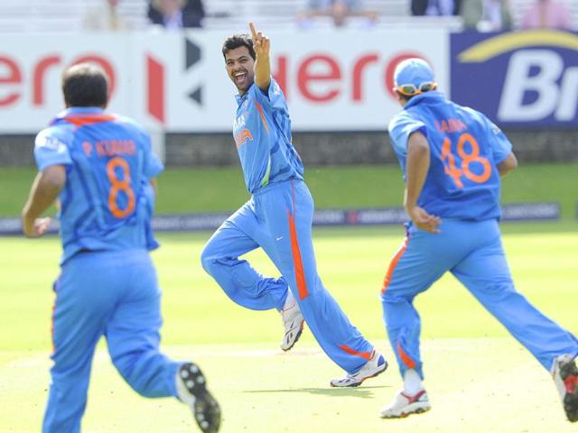 India's RP Singh, centre, celebrates after claiming the wicket of England's Alastair Cook during their one day international cricket match at Lord's cricket ground, London.