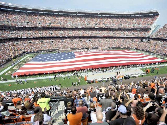 A giant flag is unveiled before the Cleveland Browns play the Cincinnati Bengals in an NFL football game in Cleveland.
