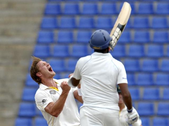 Australian cricketer Shane Watson (L) celebrates after dismissing Sri Lankan cricketer Thilan Samaraweera (R) during their fifth and final day of the second Test match.