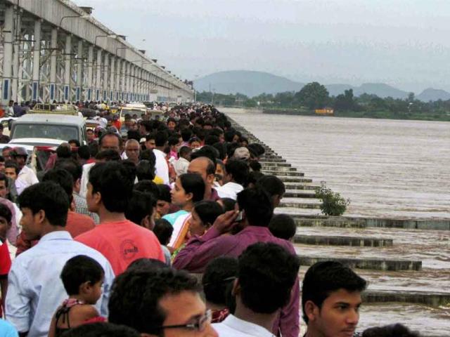 People watch the swollen Mahanadi river flowing above the danger mark near Mundali in Cuttack.