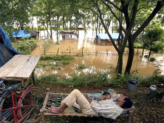 Villagers sleep near their temporary shelters after their homes were flooded by the rising waters of the River Mahanadi on the outskirts of Cuttack, about 30 kilometers from Bhubaneshwar.