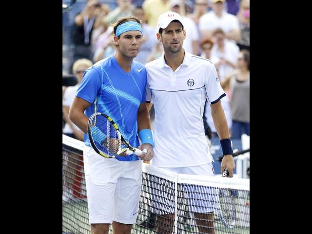 Rafael Nadal and Novak Djokovic look on before the men's championship match at the US Open tennis tournament in New York.