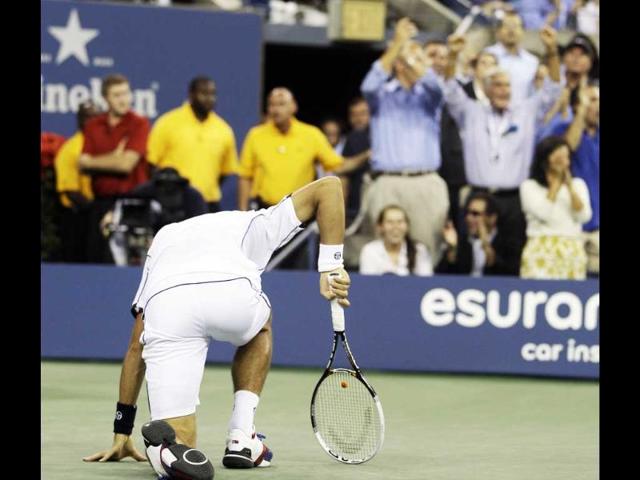 Novak Djokovic gets up after falling during the men's US Open 2011 final against Rafael Nadal.