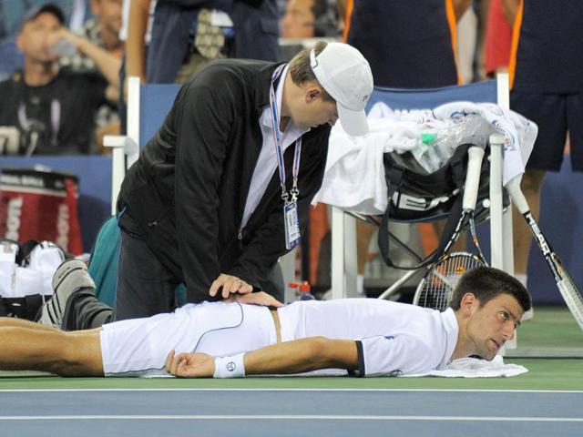 The Number one seed gets treatment from a trainer in the fourth set against number two seed Rafael Nadal during the men's US final match at the Billie Jean King National Tennis Center in New York.