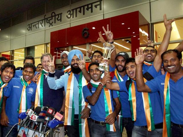 Members of the Indian hockey team flash the victory sign on their arrival at IGI airport in New Delhi.