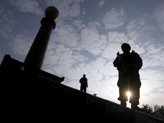 A file photo of an Afghan security guard keeping watch during the 10th anniversary of the death of Commander Ahmad Shah Massoud, in Kabul.