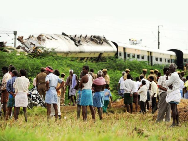 Onlookers gather around the wreckage of train carriages at Arakkonam, some 55 miles (90 kilometres) west of Chennai, after a crash between two trains in the state of Tamil Nadu. Indian railway officials have blamed driver error for a late-night collision between two passenger trains that killed nine people and injured more than 80. Emergency teams worked to clear the crash site, where five coaches were derailed in the impact. Southern Railway general manager Deepak Krishnan said initial investigations suggested the driver of the moving train, who survived the crash, had ignored speed restrictions and signal lights.