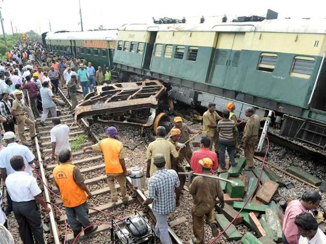 Railway officials, security personnel and onlookers gather around the wreckage of train carriages at Arakkonam, some 55 miles (90 kilometres) west of Chennai.