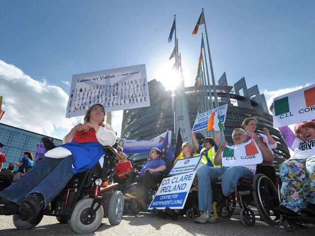 Around 200 disabled people from several European countries holding banners on their wheelchairs demonstrate in front of the European Parliament in Strasbourg, eastern France, during the fifth European Network on Independent Living Freedom Drive.
