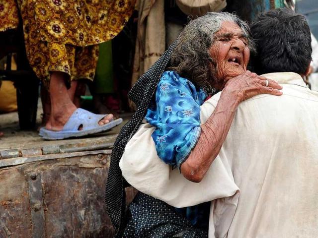 A Pakistani flood affected villager is unloaded from a truck as they arrive at a dry location in the flood-hit Badin district of Sindh province.