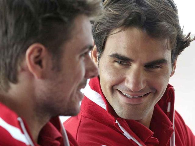 Swiss tennis teammates Roger Federer, right, and Stanislas Wawrinka share a laugh during the draw for their Davis Cup world play-off against Australia in Sydney.