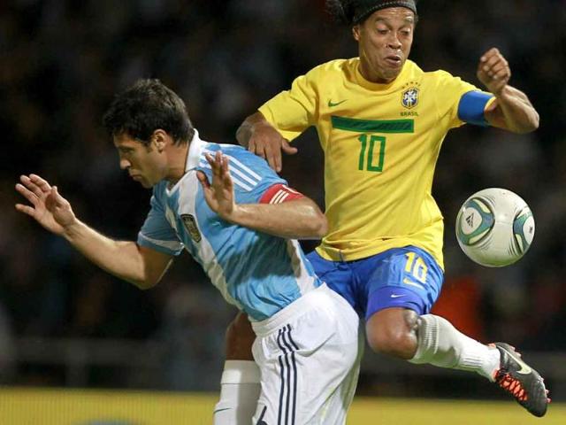 Brazil's Ronaldinho and Argentina's Sebastian Dominguez vie for the ball during a friendly soccer match in Cordoba, Argentina.