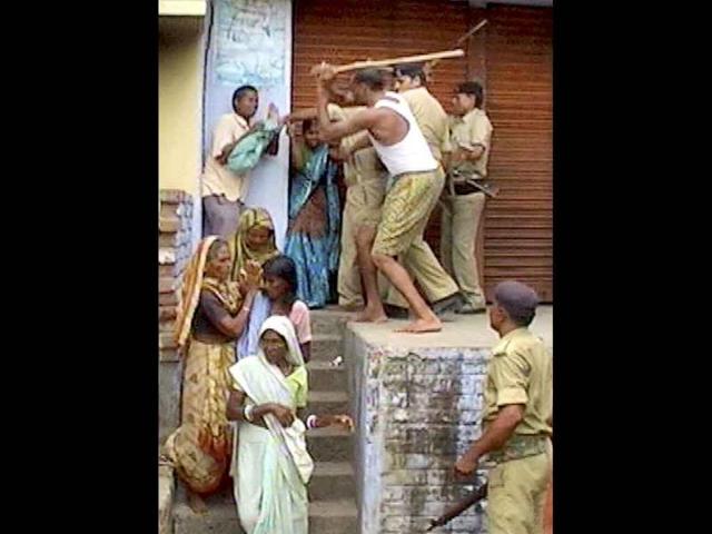 Policemen thrash one of the village women who were agitating for a missing woman near Nursarai police station in Nalanda yesterday. CM Nitish Kumar ordered a probe today.
