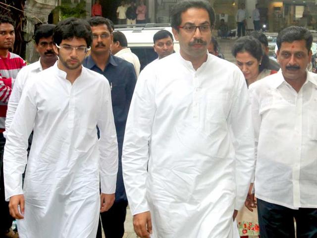 Politician Uddhav Thackeray arrives with his son.