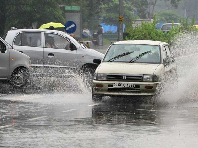 Vehicles pass through water logged streets at Inderpuri in west Delhi.