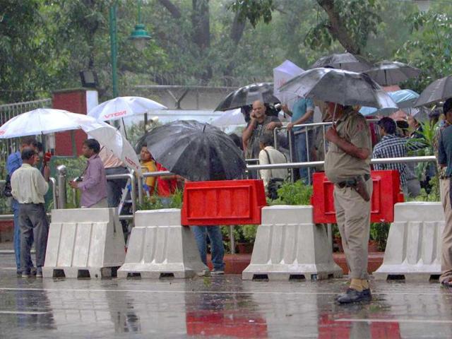 Media persons outside AICC headquarters amid heavy rains in New Delhi.