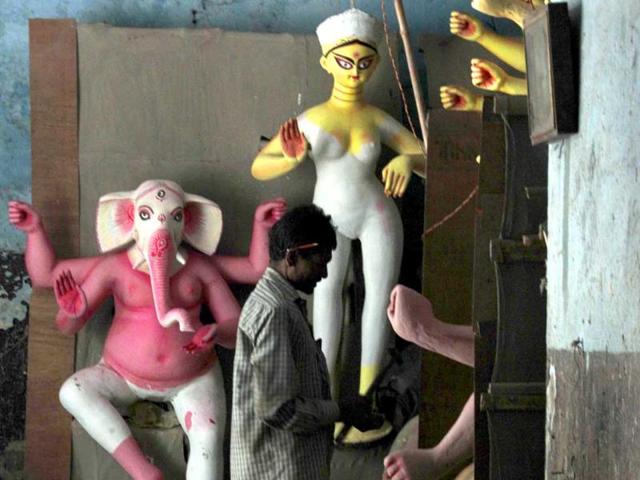 An artisan prepares an idol of Goddess Durga, ahead of the Durga Puja festival in New Delhi, India.