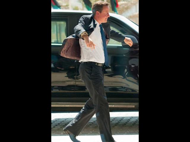 British Prime Minister David Cameron arrives at the Corinthia hotel in central Tripoli.