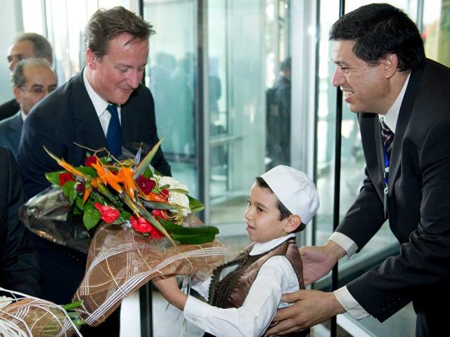 British Prime Minister David Cameron arrives at the Corinthia hotel in central Tripoli.