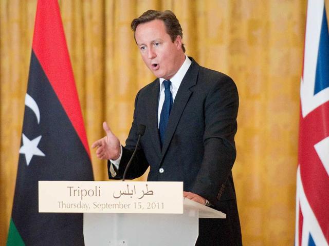 British Prime Minister David Cameron addresses the media at the Corinthia hotel in central Tripoli, pledging Britain's help in hunting down fugitive strongman Moamer Gaddafi as he and France's Nicolas Sarkozy became the first foreign leaders to visit the new Libya.