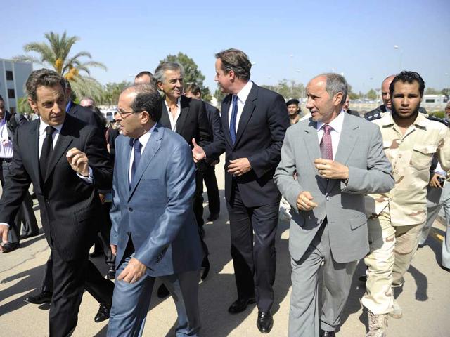 French President Nicolas Sarkozy, National Transitional Council Prime minister Mahmud Jibril, Britain's Prime minister David Cameron , NTC President Abdel Jalid and French Philosophe Bernard Henry Levy arrive at the Tripoli Medical Center during their travel in Libya.