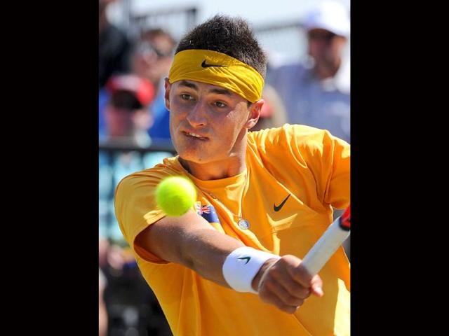 Bernard Tomic of Australia hits a return to Stanislas Wawrinka of Switzerland during their opening match of the Davis Cup tennis competition world group play-off in Sydney. Tomic won the match 4-6, 6-4, 6-3, 6-3.