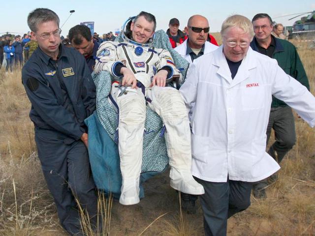 Russian space agency rescuers carry Russian cosmonaut Alexander Samokutyayev after his landing aboard the Soyuz TMA-21 space capsule about 150 km south-east of the Kazakh town of Dzhezkazgan. 