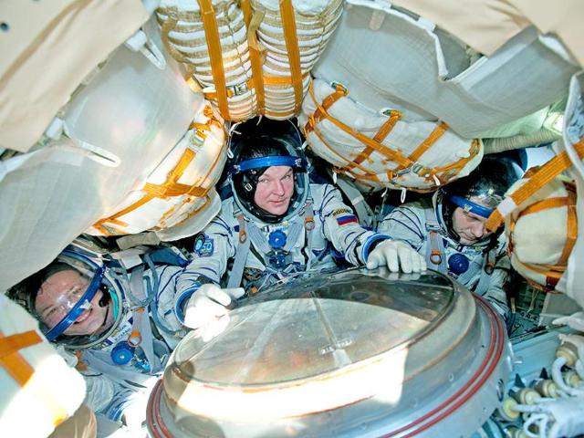 ASA Astronaut Ron Garan, left, Russian cosmonauts Alexander Samokutyayev, center, and Andrei Borisenko are seen inside Russian Soyuz TMA-21 space capsule after its landing in Kazakhstan 