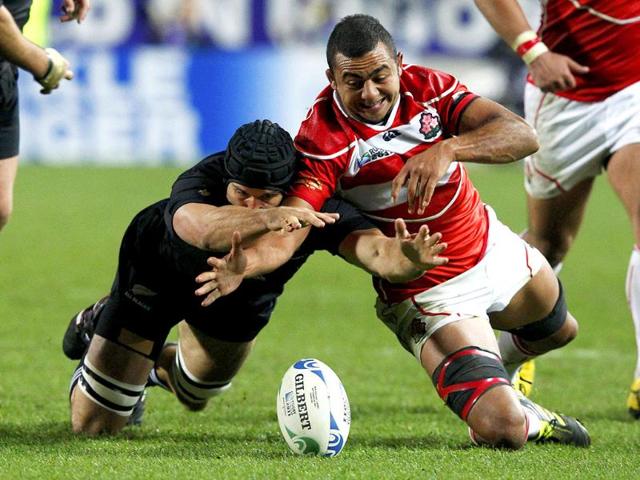 New Zealand All Blacks' Anthony Boric (L) fights for the ball with Japan's Michael Leitch during their Rugby World Cup Pool A match at Waikato Stadium in Hamilton. 
