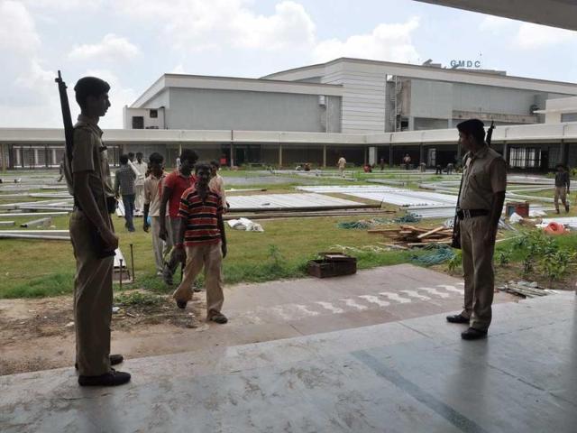 Security personnel stand guard as workers leave the venue of Narender Modi's fast in Ahmedabad today.